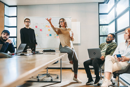 Collaborative business meeting with a diverse group of professionals in a tech company