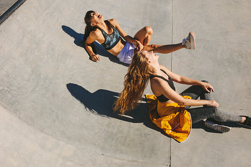 Smiling girls hanging out at skate park