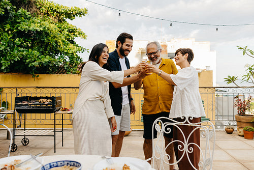 Happy family gathering during a barbecue on a charming patio