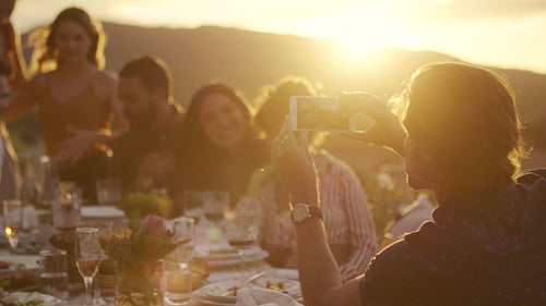 Man taking photos at dinner party