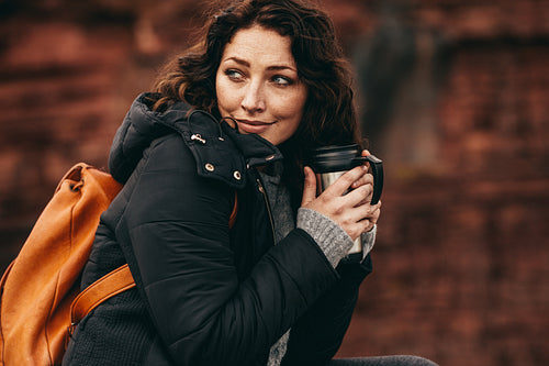 Traveler woman resting with hot tea in the mountains
