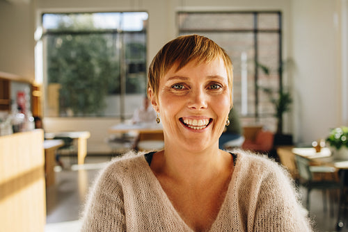 Cheerful female entrepreneur in office