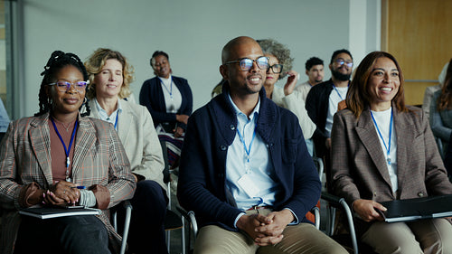 Business professionals engaged and learning in a conference setting