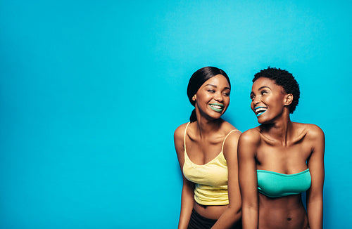 Two women standing together and smiling