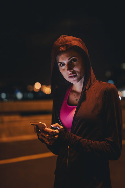 Female runner taking break after workout at night