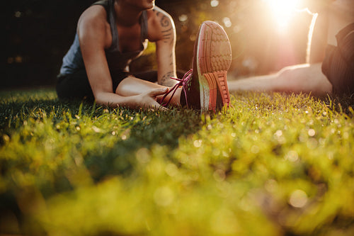Fit young woman stretching at park