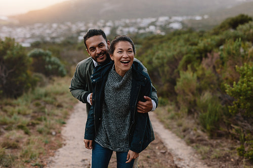 Happy young couple having fun on their countryside trip