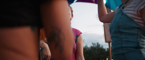 Vibrant young woman dancing with friends at a festival