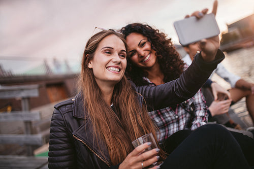 Friends taking a self portrait near the lake