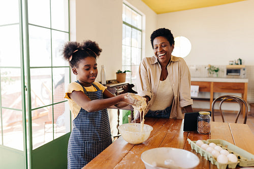 Brazilian family's joyful time in the kitchen: Mom and daughter making cheese bread together