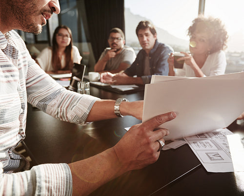 Young man explaining business plan to colleagues