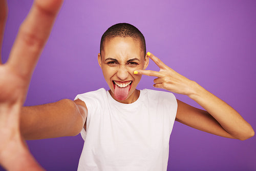 Expressive woman posing on purple background