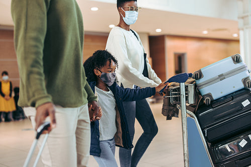 Family at airport traveling during covid-19