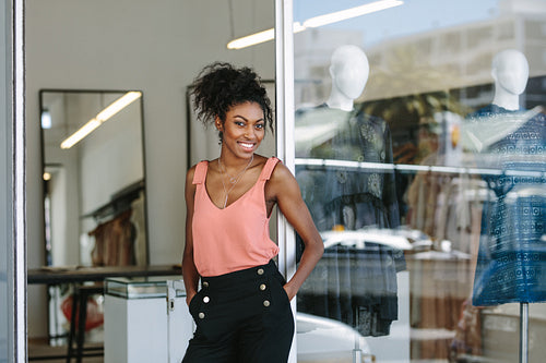 Female fashion designer standing in her boutique.