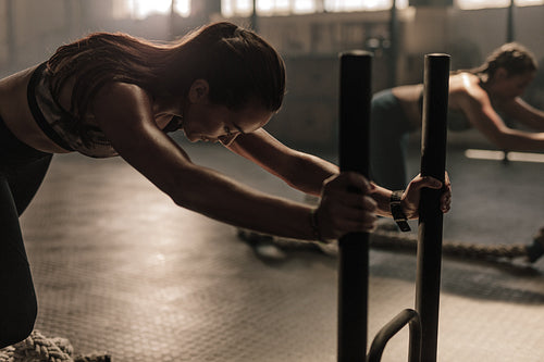 Women doing intense physical workout in gym