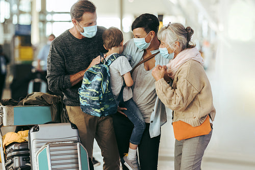 Family meeting grandmother at airport
