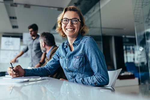 Female office worker  sitting in board room