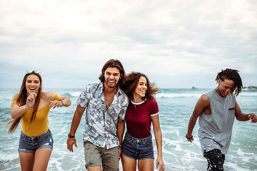 Carefree friends having fun along the beach