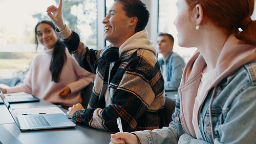 Student engagement in a college classroom: Male student asking a question in class