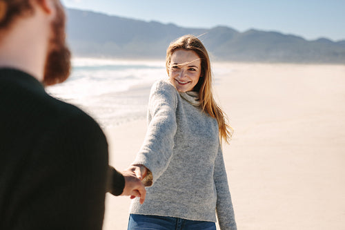 Loving couple walking together at the beach