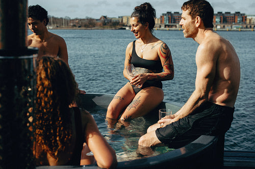 A hot tub scene shows people unwinding by the waterfront for leisure.
