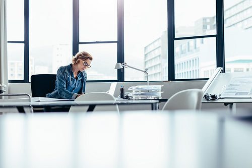 Businesswoman looking busy working on laptop