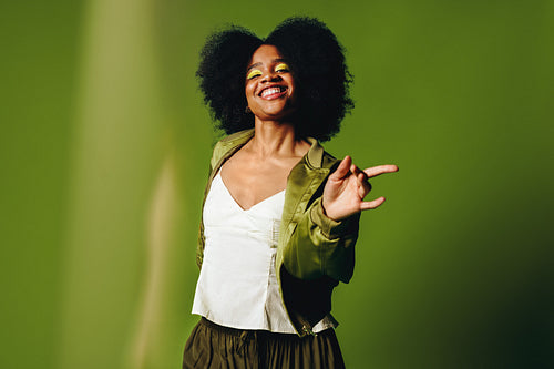 Dancing woman brings joyful lifestyle energy to a confident studio portrait