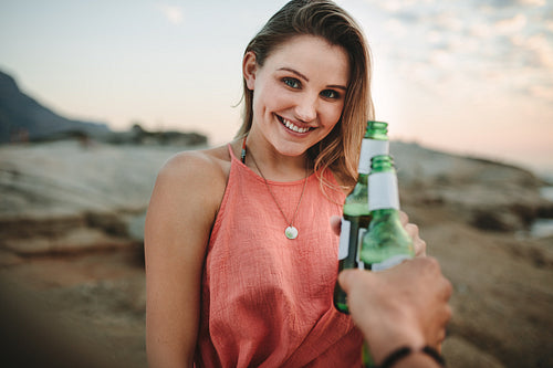 Woman on a holiday standing at the beach enjoying drinks