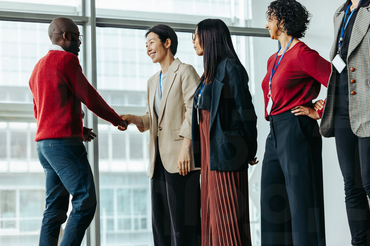 Successful team introduction at a corporate meeting with diverse profe ...