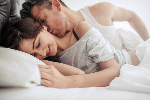 Beautiful romantic couple foreplay in bed