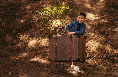 Boy pretending to be going on vacation