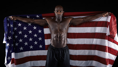 African muscular male holding American Flag