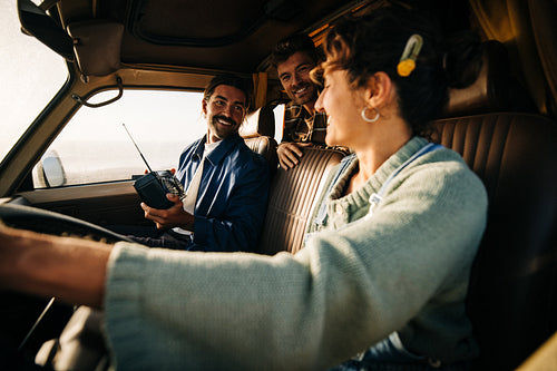 Friends road trip: Three friends in a car sharing smiles