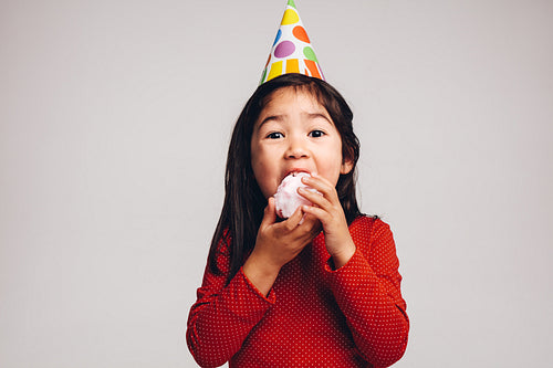 Portrait of an asian kid eating candy floss