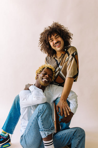 Happy gay couple smiling at the camera