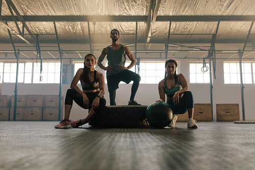 Young people resting after exercising at gym