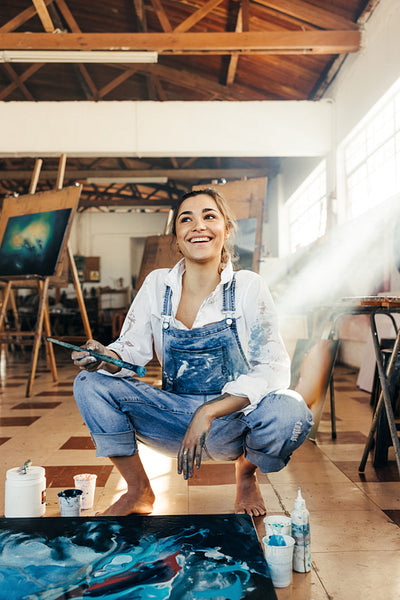 Inspired young artist looking away with a smile