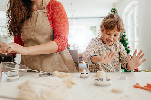 Mother and daughter preparing Christmas cookies.