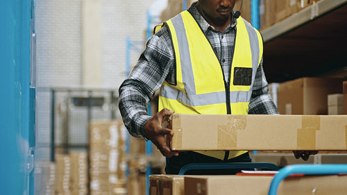 Voice directed warehousing: Warehouse worker uses a headset to pick orders for shipping