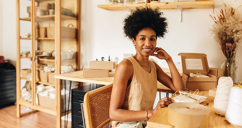 Entrepreneur in studio with jewelry package for delivery