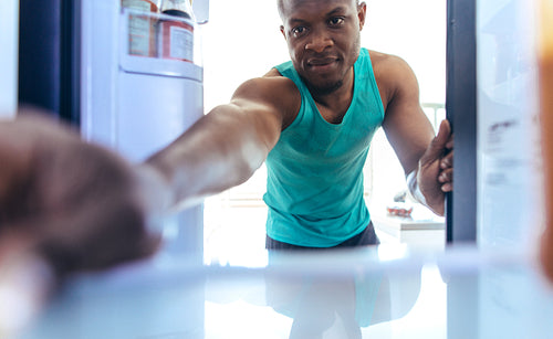 Man using refrigerator at home