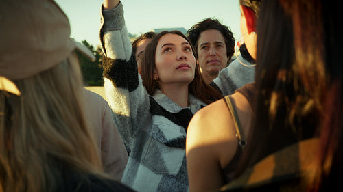 People gather holding blank protest sign