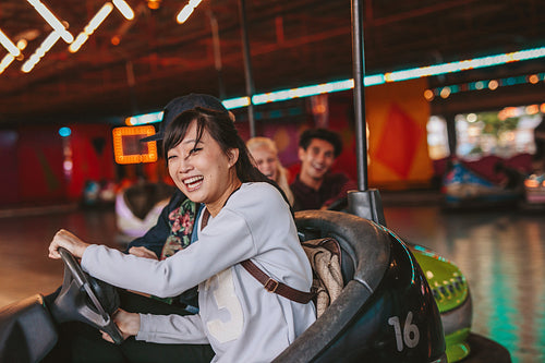Happy young girl driving a bumper car