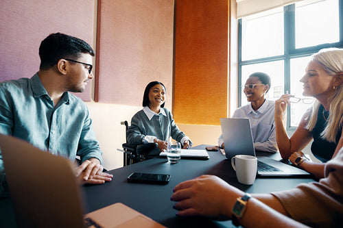 Diverse professionals in a business meeting in a modern workspace