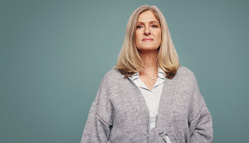Confident mature woman looking at the camera in a studio