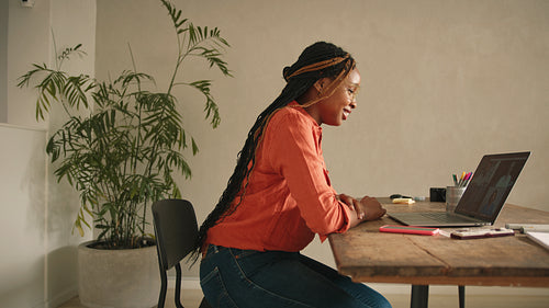 Cheerful designer communicating with her clients online