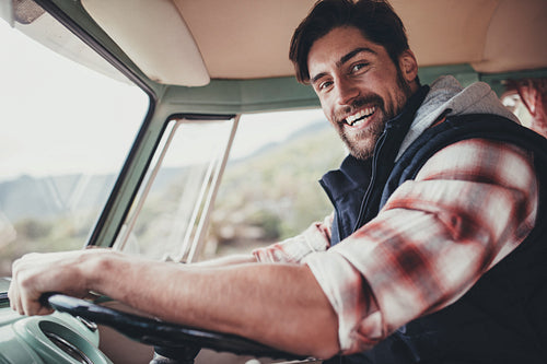 Handsome man driving van on his road trip