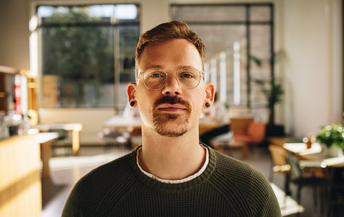 Confident male entrepreneur at co-working office
