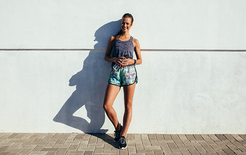 Healthy female relaxing after running exercise