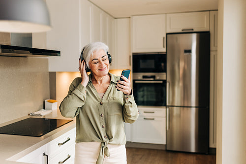 Senior woman enjoying her favourite music at home